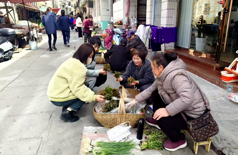 顧客正在攤位前挑選新鮮的野菜。王輝攝